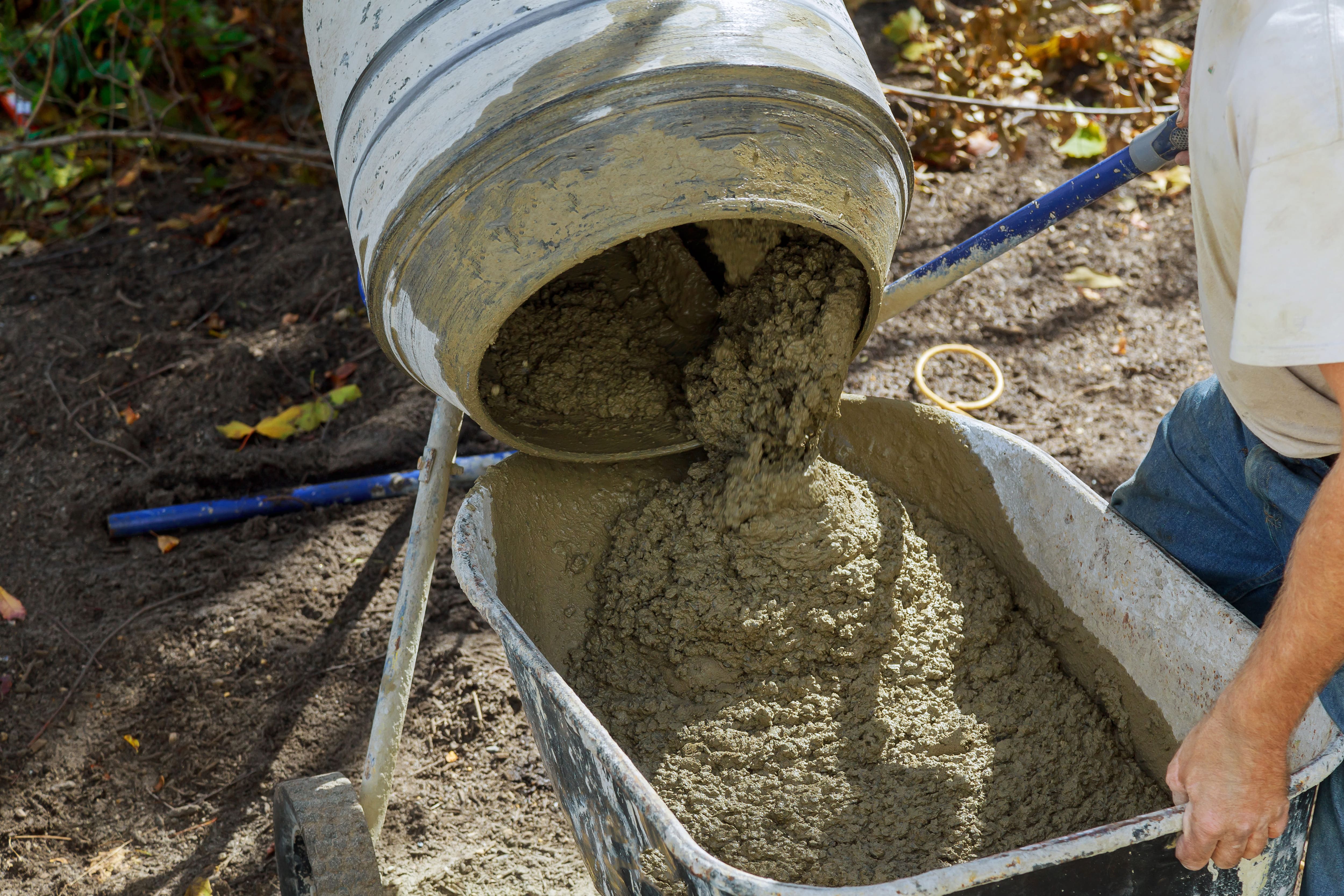 worker uses a concrete made of in the concrete mixer at building construction works 1 1